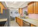 Well lit kitchen showcasing light wood cabinetry and stainless steel appliances at 109 Woodfield Ct, Sanford, FL 32773