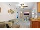 Bright living room showcasing modern decor, ceiling fan and sightlines to the entry and kitchen at 109 Woodfield Ct, Sanford, FL 32773