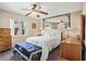 Comfortable main bedroom featuring a ceiling fan, mirror accent, and a cozy carpet at 109 Woodfield Ct, Sanford, FL 32773