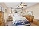 Relaxing main bedroom featuring a ceiling fan, mirror accent, and soft, inviting carpet at 109 Woodfield Ct, Sanford, FL 32773