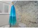 Close-up of a shower with textured walls and a blue ocean-themed shower curtain hanging from a curved shower rod at 109 Woodfield Ct, Sanford, FL 32773