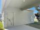View of covered back porch with doorway overlooking a green lawn at 11070 Longleaf Woods Dr, Orlando, FL 32832