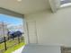 View of covered back porch with doorway and fenced in back yard with parked car at 11070 Longleaf Woods Dr, Orlando, FL 32832