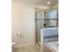 Bathroom featuring a glass-enclosed shower, soaking tub with tiled accents, and a modern, streamlined design at 11070 Longleaf Woods Dr, Orlando, FL 32832