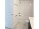 Cozy bathroom features white tiled shower and white tiled flooring at 11070 Longleaf Woods Dr, Orlando, FL 32832