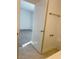 Looking into a bedroom from the bathroom with gray carpet and a window at 11070 Longleaf Woods Dr, Orlando, FL 32832