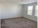 Sunlit bedroom featuring plush carpeting, clean lines, and bright white walls with natural light from the windows at 11070 Longleaf Woods Dr, Orlando, FL 32832