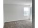 This bedroom features a window and a door to the right of the room at 11070 Longleaf Woods Dr, Orlando, FL 32832