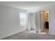 This carpeted bedroom features a closet and a door to the bathroom at 11070 Longleaf Woods Dr, Orlando, FL 32832