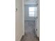 Bedroom hallway view with neutral carpet and freshly painted walls, leading to a bright room with a window at 11070 Longleaf Woods Dr, Orlando, FL 32832
