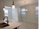 Bright dining area featuring a modern chandelier and natural light at 11070 Longleaf Woods Dr, Orlando, FL 32832