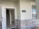 Inviting entry with stone accents, showcasing the staircase, tiled flooring, and house number at 11070 Longleaf Woods Dr, Orlando, FL 32832