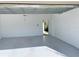 Spacious and clean two-car garage with bright, neutral walls, and a gray floor at 11070 Longleaf Woods Dr, Orlando, FL 32832