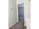 Bright hallway with carpeted floors and white walls leading to a bedroom at 11070 Longleaf Woods Dr, Orlando, FL 32832