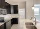 Modern kitchen featuring dark cabinetry, stainless appliances, and quartz countertops at 11070 Longleaf Woods Dr, Orlando, FL 32832