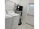 Functional laundry room includes washer, dryer, and water heater at 11070 Longleaf Woods Dr, Orlando, FL 32832