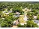 Overhead view of a solar-paneled home featuring a kidney-shaped pool in a tree-lined neighborhood at 12 Horseman Cv, Longwood, FL 32750