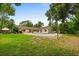 Large backyard with plenty of green grass, trees, and pool at 12 Horseman Cv, Longwood, FL 32750