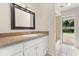 The bathroom features a framed mirror, tile counters, and convenient access to the pool area at 12 Horseman Cv, Longwood, FL 32750