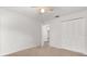 Bedroom with carpet, a ceiling fan, and a closet for storage at 12 Horseman Cv, Longwood, FL 32750