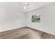A bright bedroom features hardwood flooring and a ceiling fan for comfort at 12 Horseman Cv, Longwood, FL 32750