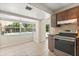 Bright eat-in kitchen featuring dark wooden cabinets, stainless steel range, and pool views at 12 Horseman Cv, Longwood, FL 32750