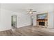 Bright and airy living room featuring a stone fireplace, hardwood floors, and neutral paint at 12 Horseman Cv, Longwood, FL 32750
