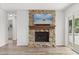 Cozy living room featuring a stone fireplace with wooden mantle and hardwood floors at 12 Horseman Cv, Longwood, FL 32750