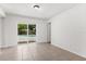 Bright living room with tile floor, and sliding glass doors to the outdoor pool area at 12 Horseman Cv, Longwood, FL 32750