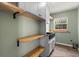 Walk-in pantry features wood shelving, a utility sink, and natural light from the window at 12 Horseman Cv, Longwood, FL 32750