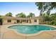 Backyard features a kidney-shaped pool and patio area, perfect for outdoor entertaining at 12 Horseman Cv, Longwood, FL 32750