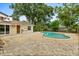 Relaxing backyard oasis featuring a kidney-shaped pool, spacious patio, and mature landscaping at 12 Horseman Cv, Longwood, FL 32750
