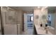 This bathroom boasts a glass shower, double sink vanity, and a beautiful view into the bedroom at 1201 Challenge Dr, Davenport, FL 33896
