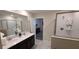 This bathroom has a double vanity with lots of space and a sleek shower with a glass door at 1201 Challenge Dr, Davenport, FL 33896