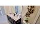Modern bathroom with double sinks, sleek cabinetry, and decorative butterfly accents at 1201 Challenge Dr, Davenport, FL 33896