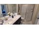Modern bathroom with double sinks, a glass-enclosed shower, and marble floors at 1201 Challenge Dr, Davenport, FL 33896