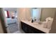 This spacious bathroom features double sinks and an open view of the bedroom for a relaxing experience at 1201 Challenge Dr, Davenport, FL 33896