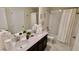 Clean bathroom with a double sink vanity, marble floors, and shower/tub combo at 1201 Challenge Dr, Davenport, FL 33896
