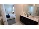 Well-lit bathroom featuring double sinks, marble floors, and a view into the bedroom at 1201 Challenge Dr, Davenport, FL 33896