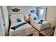 Inviting bedroom featuring two twin beds, unique decor, and neutral tones at 1201 Challenge Dr, Davenport, FL 33896
