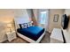 Cozy bedroom featuring a plush bed with blue accents and elegant decor at 1201 Challenge Dr, Davenport, FL 33896