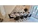 Dining room with a modern table set for ten, complemented by stylish decor and pool view at 1201 Challenge Dr, Davenport, FL 33896