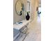 Elegant entryway with a decorative mirror, stylish console table, and floral accents at 1201 Challenge Dr, Davenport, FL 33896