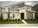 Modern two-story home with a stone facade and well-maintained landscaping at 1201 Challenge Dr, Davenport, FL 33896