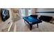 Spacious game room with a pool table, futons, and modern decor at 1201 Challenge Dr, Davenport, FL 33896