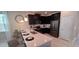 Stylish kitchen with dark cabinets, stainless steel appliances, and a bright, spacious island at 1201 Challenge Dr, Davenport, FL 33896