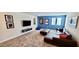 Spacious living room with large sectional sofa and flat-screen TV; perfect for movie nights at 1201 Challenge Dr, Davenport, FL 33896