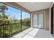 A relaxing screened balcony with a beautiful view of lush greenery and blue skies at 1269 Long Cove Loop # 1269, Davenport, FL 33896