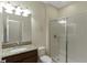 Bathroom featuring granite counters, a glass shower, and vanity lighting at 1269 Long Cove Loop # 1269, Davenport, FL 33896