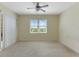 Bright, carpeted bedroom features a ceiling fan and a large window for abundant natural light at 1269 Long Cove Loop # 1269, Davenport, FL 33896